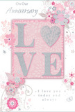 This anniversary card is depicted as a gentle tribute to enduring romance, its colours and details echoing the soft atmosphere of an evening in Coulsdon. The centrepiece is the word LOVE, composed in raised, glittering letters that feel velvety to the touch, with the letter O replaced by a shimmering silver heart. This heart has a subtly textured, slightly mirrored surface, symbolising the bright core of a long relationship and catching the light like a polished pendant in a cosy Brighton Road shop. Around this focal motif, delicate blossoms in blush, mauve, and muted ivory open with almost watercolour softness, their edges slightly blurred as if painted with a fine brush on damp paper. Flowing lines suggest stems and tendrils, arcing gracefully across the card like climbing roses along a garden fence near Coulsdon Common. Small decorative flourishes-tiny petals, fine swirls, and discreet butterflies-add movement and whimsy while remaining tastefully understated. The background is a tranquil pastel pink, allowing the silver and white highlights to gleam gently rather than shine harshly. Elegant script inscriptions, including On Our Anniversary and I love you today and always, are written in a calm, graceful hand that feels personal and sincere, as if penned thoughtfully for one special person. The overall composition conveys a sense of occasion and intimacy, like a keepsake one might tuck away in a drawer with old photographs, perfectly complementing a fresh anniversary bouquet delivered across Coulsdon to mark another chapter in a shared journey.